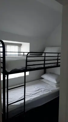 a couple of bunk beds in a room at Menadue Cottage, Trenale Lane, Tintagel, Cornwall in Treknow
