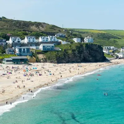 a group of people on a beach near the ocean at Cosy Cottage Close to the Beach with Hot Tub in Carnbrea Station