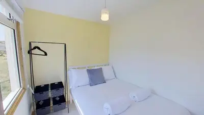 a small room with a bed and a mirror at F04 Penrhys, Rivere Towans in Hayle