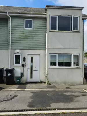 a house with a white door and a driveway at House in Cornwall in Redruth