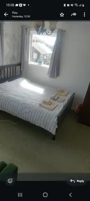 a bed in a room with a window and a bedvisor at Minnadhu in Porthleven