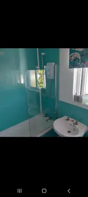 a bathroom with a mirror and a sink at Minnadhu in Porthleven