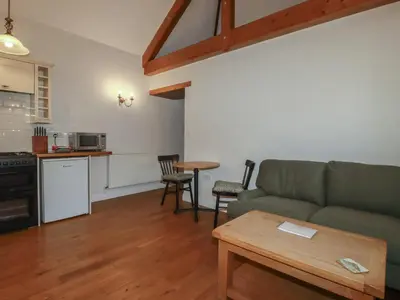 a living room with a couch and a table at The Copper House in Truro