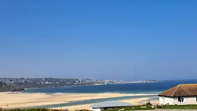 a view of a beach with a house and the ocean at D26 Vu-An-Tecca, Riviere Towans in Hayle