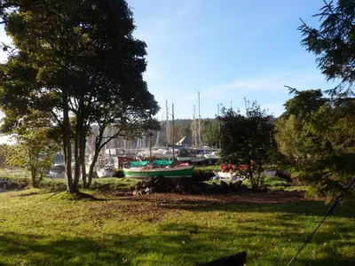 a group of boats are docked in a field at Little Acorns in Helston