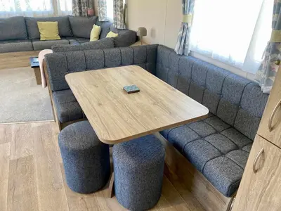 a wooden table with two chairs and a couch at The Bolt Hole Polperro in Polperro