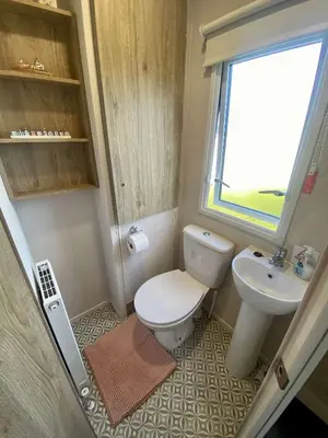 a small bathroom with a toilet and a sink at The Bolt Hole Polperro in Polperro
