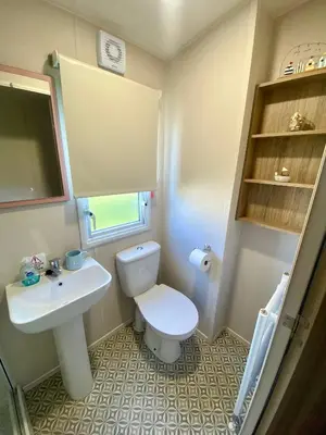 a small bathroom with a toilet and a sink at The Bolt Hole Polperro in Polperro