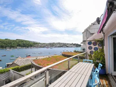 a balcony with a view of a body of water at 5 Esplanade in Fowey