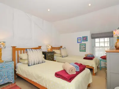 a bedroom with two beds with towels on them at 5 Esplanade in Fowey