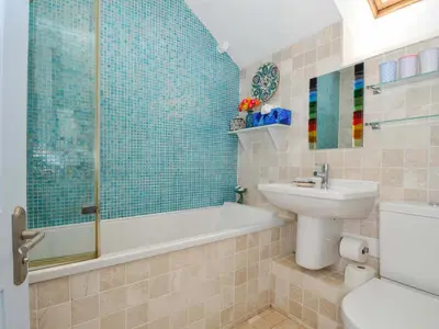 a bathroom with a sink and a toilet and a shower at 5 Esplanade in Fowey