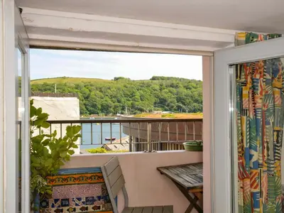 a balcony with a view of the water at 5 Esplanade in Fowey