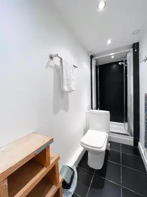 a bathroom with a white toilet and a window at SURF PAD in St Ives, 1 Bed Apartment , 400M to Beach & Harbour in St Ives