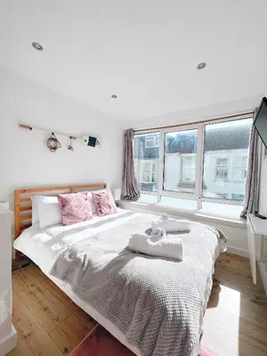 a bedroom with a bed with two towels on it at SURF PAD in St Ives, 1 Bed Apartment , 400M to Beach & Harbour in St Ives