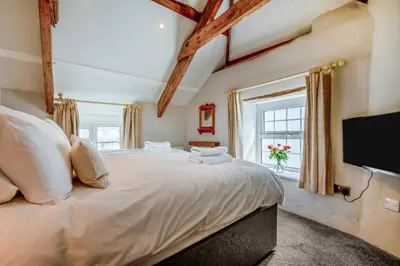 a bedroom with a large bed with a flat screen tv at 3 Bed in Egloshayle oc-m32201 in Egloshayle