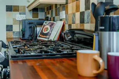 a stove top with a book on it in a kitchen at 3 Bed in Egloshayle oc-m32201 in Egloshayle