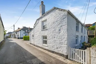 a white stone house on the side of a street at 3 Bed in Egloshayle oc-m32201 in Egloshayle
