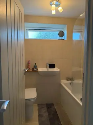a bathroom with a toilet and a sink and a tub at Shorething in Saint Martin