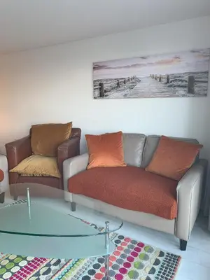 a living room with a couch and a glass table at Shorething in Saint Martin