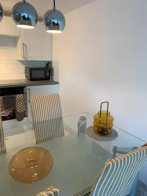 a kitchen with a glass table and two chairs at Shorething in Saint Martin