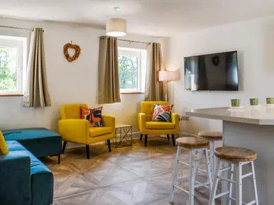 a living room with yellow chairs and a table at 3 Le Dorney Villa - Uk49820 in Par
