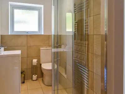 a bathroom with a toilet and a sink and a window at 3 Le Dorney Villa - Uk49820 in Par