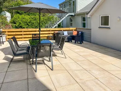 a patio with a table and chairs and an umbrella at 3 Le Dorney Villa - Uk49820 in Par