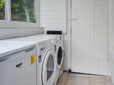 a washing machine in a white laundry room with a window at 2 Le Dorney Villa - Uk49804 in Par