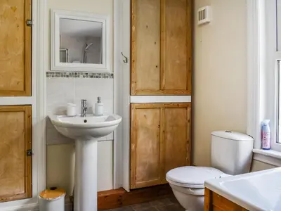 a bathroom with a white toilet and a sink at 2 Le Dorney Villa - Uk49804 in Par
