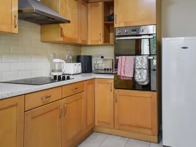 a kitchen with wooden cabinets and stainless steel appliances at 2 Le Dorney Villa - Uk49804 in Par