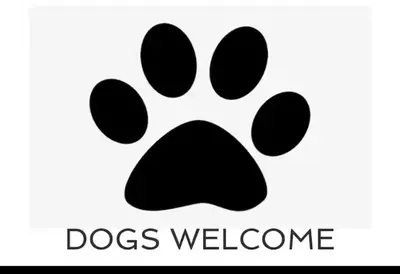 a black dog paw print with the text dogs welcome at Pufflings, Padstow Coastal Cottage, Free Private Parking in Padstow