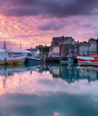 a group of boats docked in a harbor at sunset at Pufflings, Padstow Coastal Cottage, Free Private Parking in Padstow