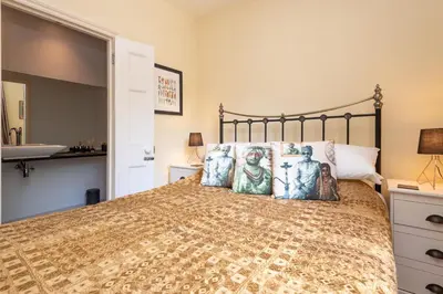 a bedroom with a bed and a sink at The Vicarage - Grand Country House, Walking Distance to Padstow and with Pub Across the Road in Wadebridge