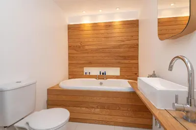 a bathroom with a tub and a toilet and a sink at The Vicarage - Grand Country House, Walking Distance to Padstow and with Pub Across the Road in Wadebridge