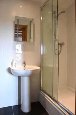 a bathroom with a sink and a shower at Ash Cottage, 3 bed large cottage in Tregoney