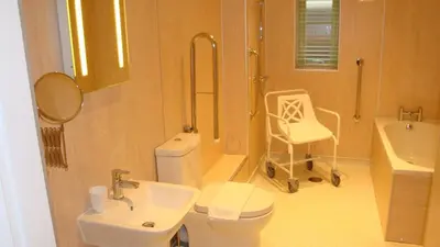 a bathroom with a toilet and a sink and a shower at Elm Cottage Delightful 2 bed accessible holiday cottage in Tregoney