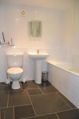 a bathroom with a toilet and a sink and a tub at Hawthorn Cottage Luxury stone Built Cottage in Tregoney