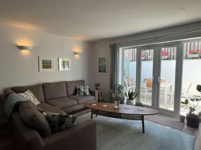 a living room with a couch and a table at Meadowvine in Penryn