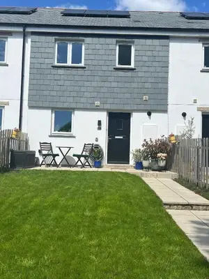 a house with a lawn in front of it at Meadowvine in Penryn