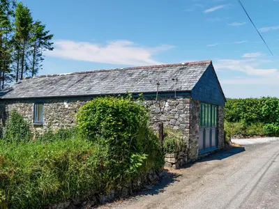 a stone house with a slate roof on a road at The Shippen - Uk49830 in Callington