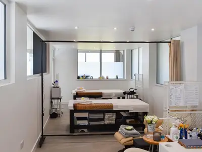 a bedroom with a bed and a mirror at Little Palms in Bude