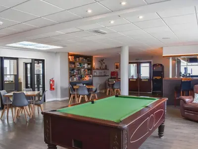 a pool table in the middle of a room at Little Palms in Bude