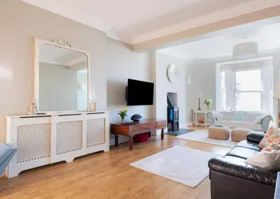 a living room with a mirror and a couch at 1 The Terrace in Padstow