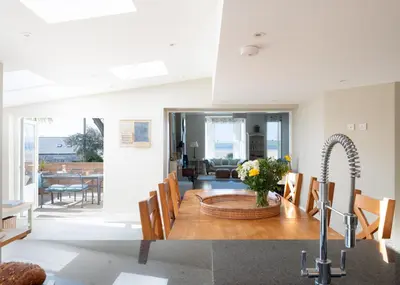 a kitchen and dining room with a table and a sink at 1 The Terrace in Padstow