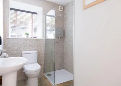a bathroom with a shower and a toilet and a sink at 1 The Terrace in Padstow