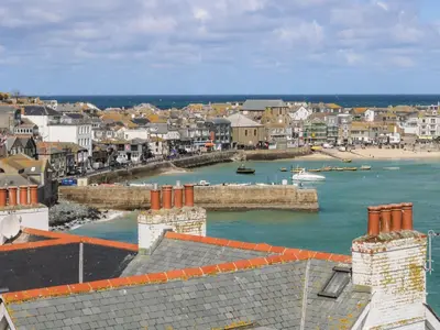 a view of a town with a body of water at Candle Croft in Redruth