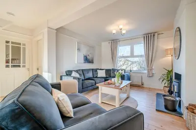 a living room with a couch and a table at 5 Bed in Mitchell oc-c30790 in Mitchell