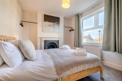 a bedroom with a bed with a fireplace and a window at 5 Bed in Mitchell oc-c30790 in Mitchell