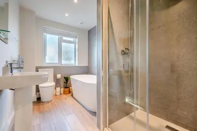 a bathroom with a shower and a tub and a sink at 5 Bed in Mitchell oc-c30790 in Mitchell