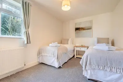 two beds in a room with a window at 5 Bed in Mitchell oc-c30790 in Mitchell